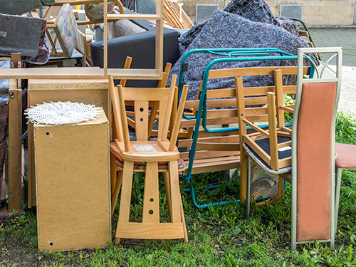 residential junk sitting in front of house.