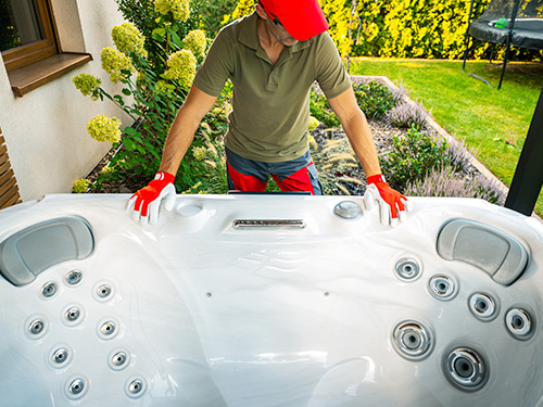 Technician assessing a hot tub for removal.
