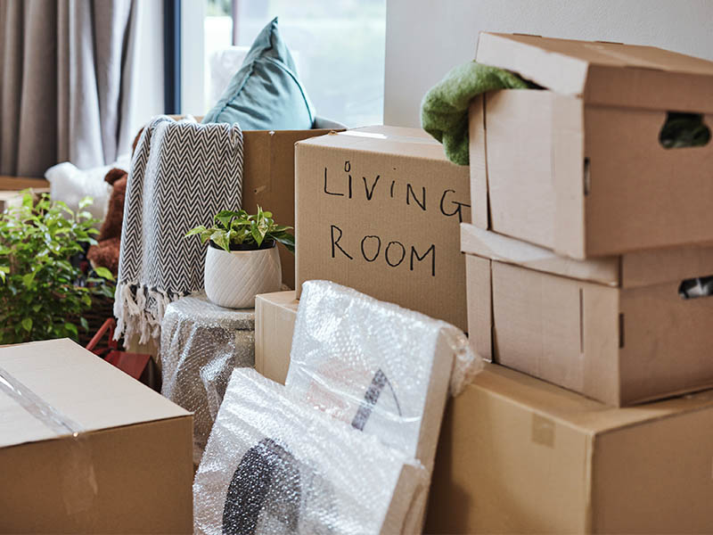 Boxes and items stacked up in a home in preparation for moving.