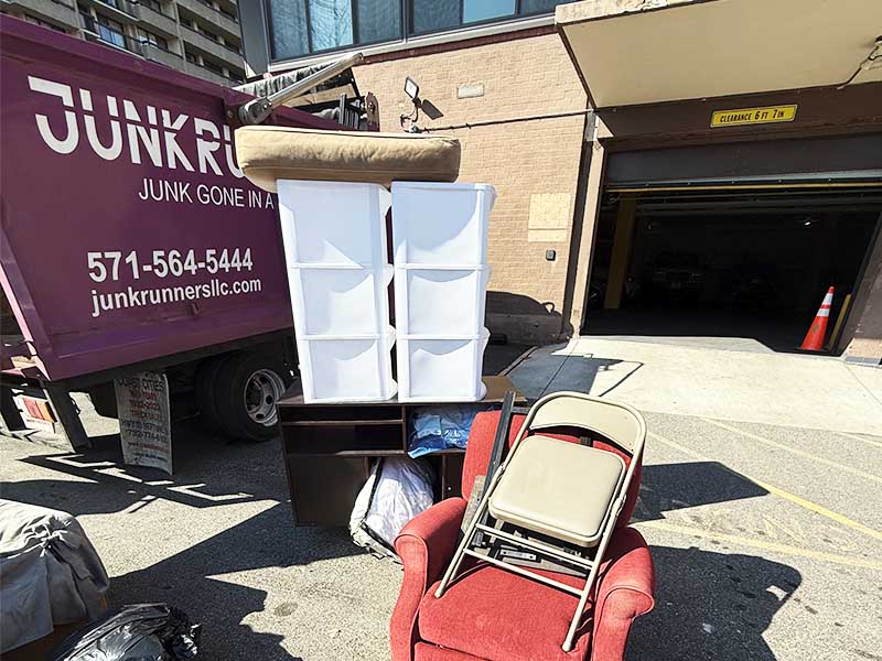 Bulky furniture sitting next to Junk Runners truck, waiting to be loaded.