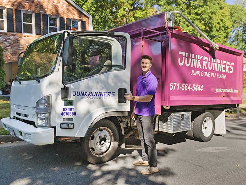 Junk Runners worker getting into truck.