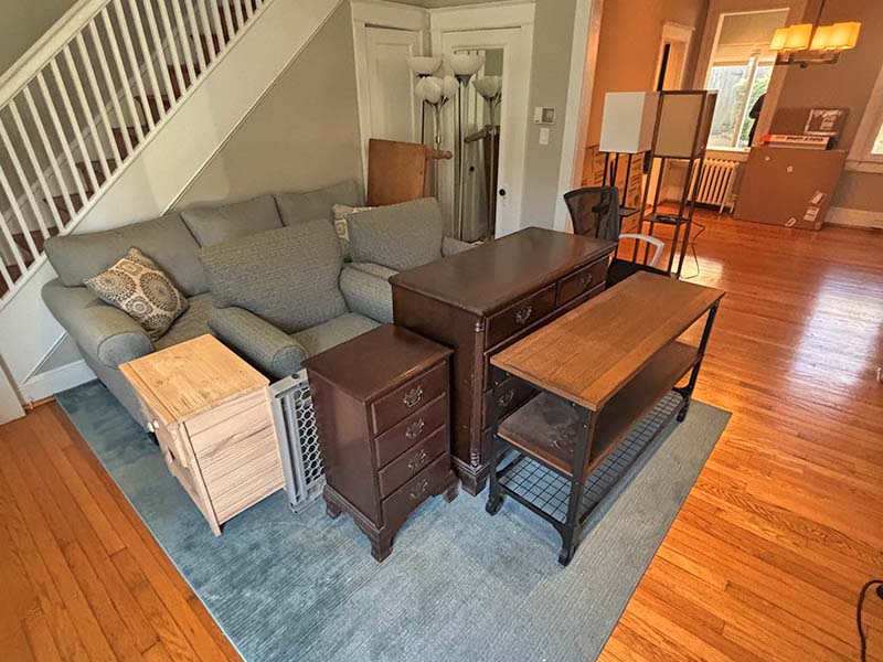 Living room filled with pieces of furniture.