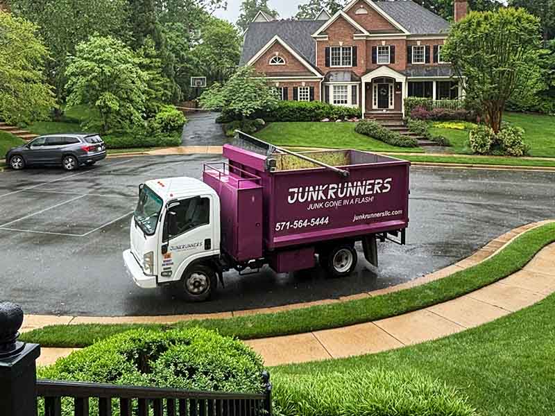 Junk Runners truck parked in residential neighborhood.